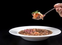 Pressure Cooker (Instant Pot) Smoky Ham Hock and Pinto Bean Soup in a white bowl