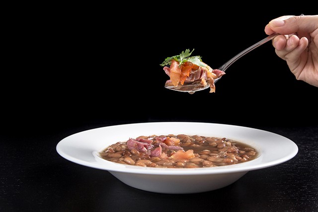 Pressure Cooker (Instant Pot) Smoky Ham Hock and Pinto Bean Soup in a white bowl