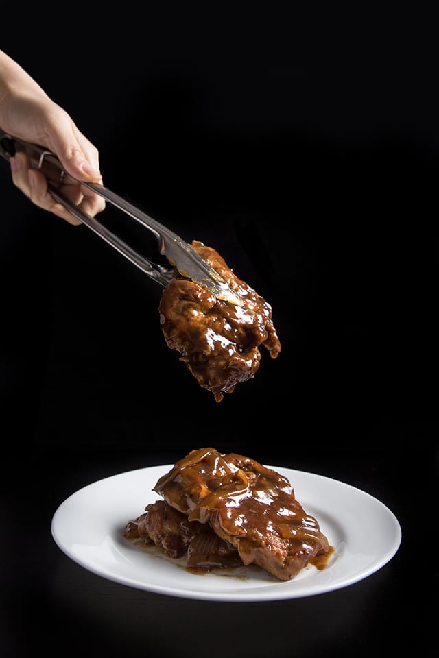 Pressure Cooker Pork Chops in HK Onion Sauce on a white dinner plate