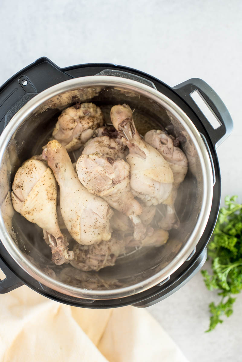 Overhead shot of honey sriracha chicken drum sticks being cooked in an Instant Pot.