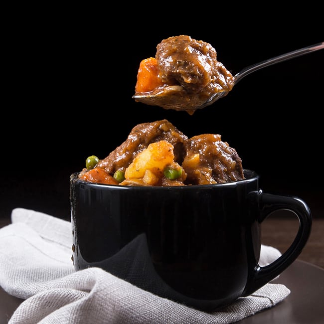 black soup mug of pressure cooker beef stew