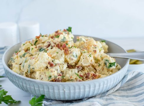 Close up picture of Instant Pot BLT potato salad with fresh parsley in the corner.