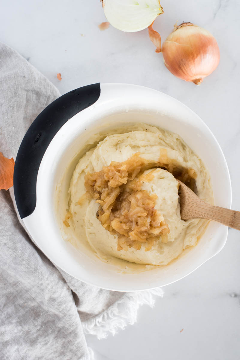 stirring caramlized onions into mashed potatoes