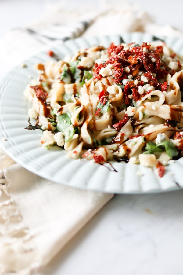 White dinner plate with Cauliflower Fettuccine Alfredo made in an electric pressure cooker