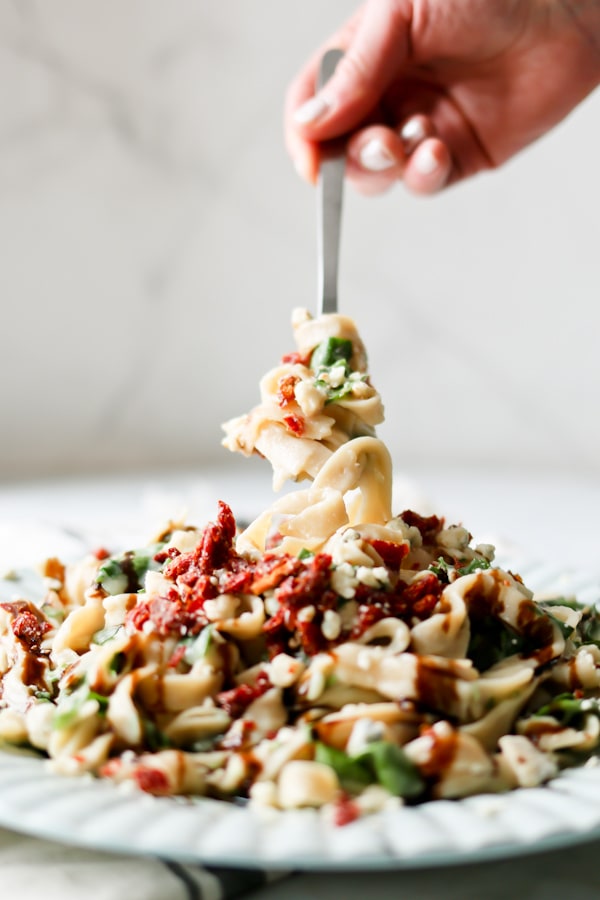 Pressure Cooker Cauliflower Fettuccine Alfredo twirled onto a dinner fork