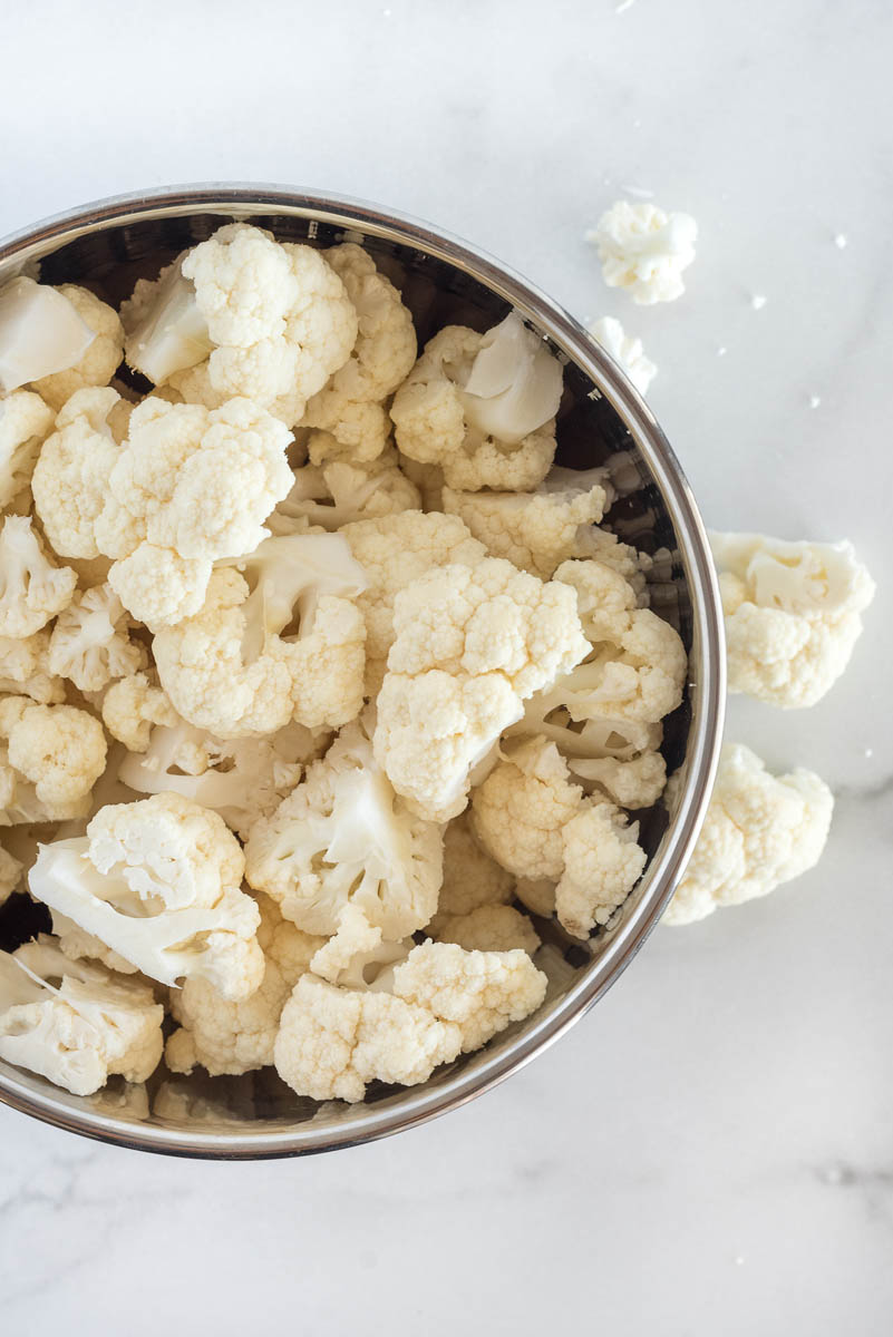 an overhead shot of cauliflower, washed and sliced in to large pieces