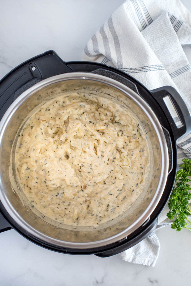 Overhead shot showing the hash brown casserole cooked and mixed inside an Instant Pot.