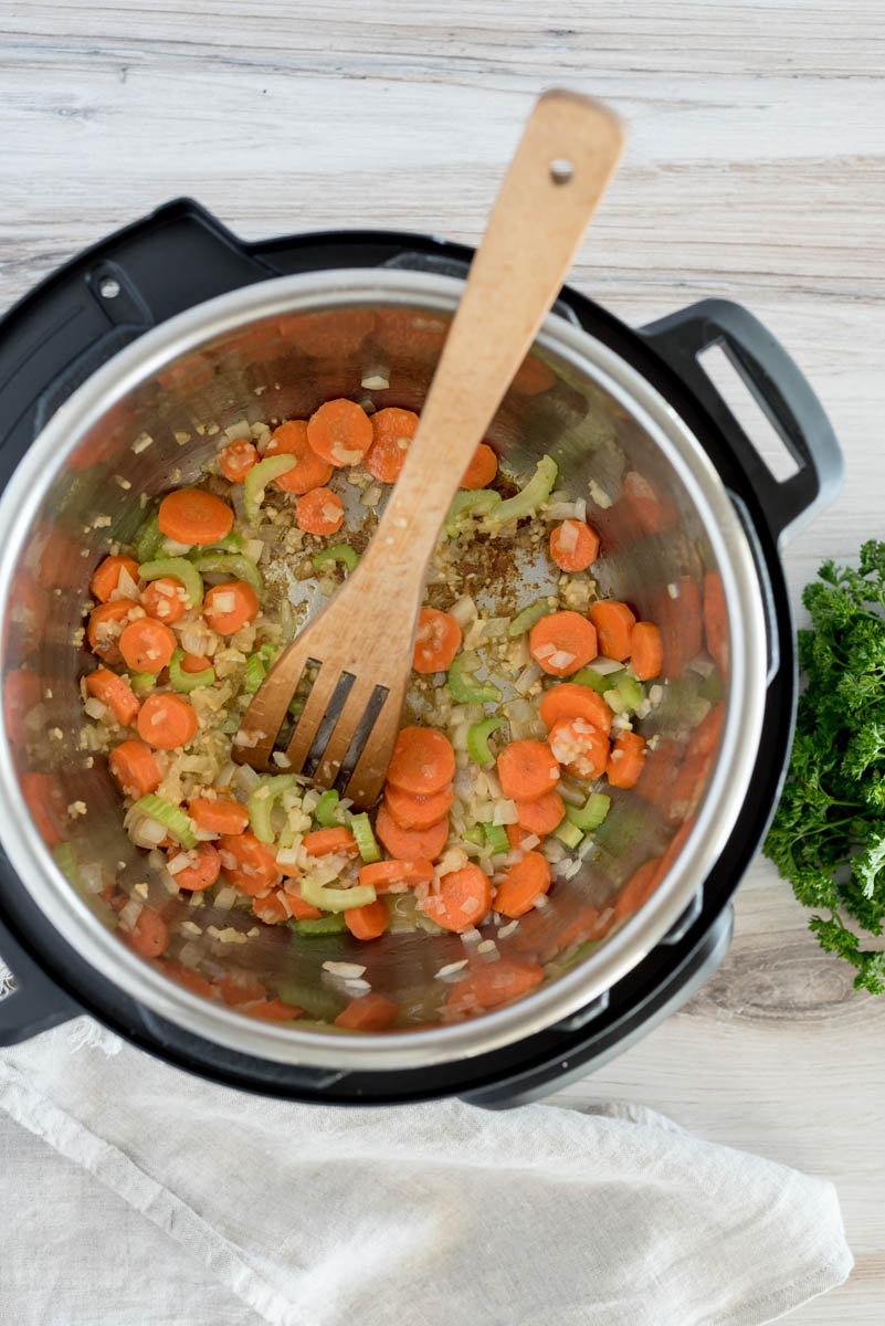 Sautéing carrots, celery and onion in an Instant Pot for chicken and dumplings.