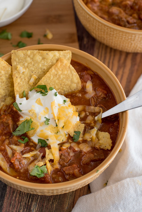 Beef and Bean Instant Pot Chili with sour cream, cheddar cheese, cilantro, and tortilla chips