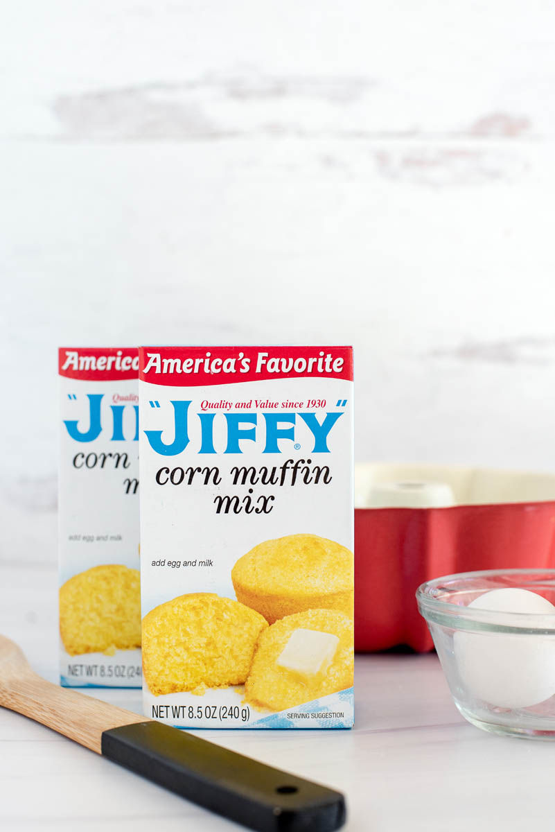 ingredients for cornbread with jiffy muffin mix, eggs and a bundt pan