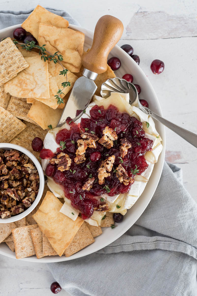 plate of cranberry baked brie with crackers