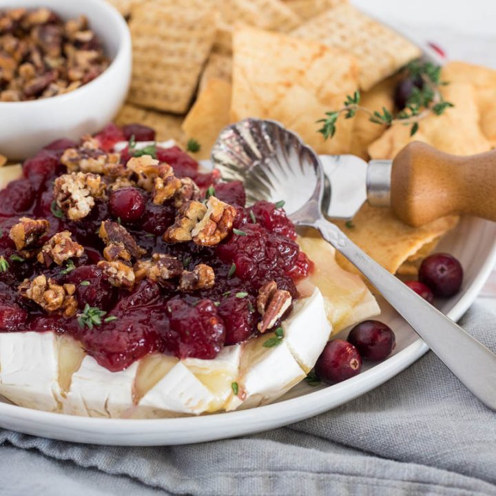 plate of cranberry baked brie with crackers