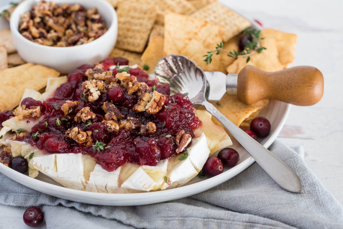 plate of cranberry baked brie with crackers