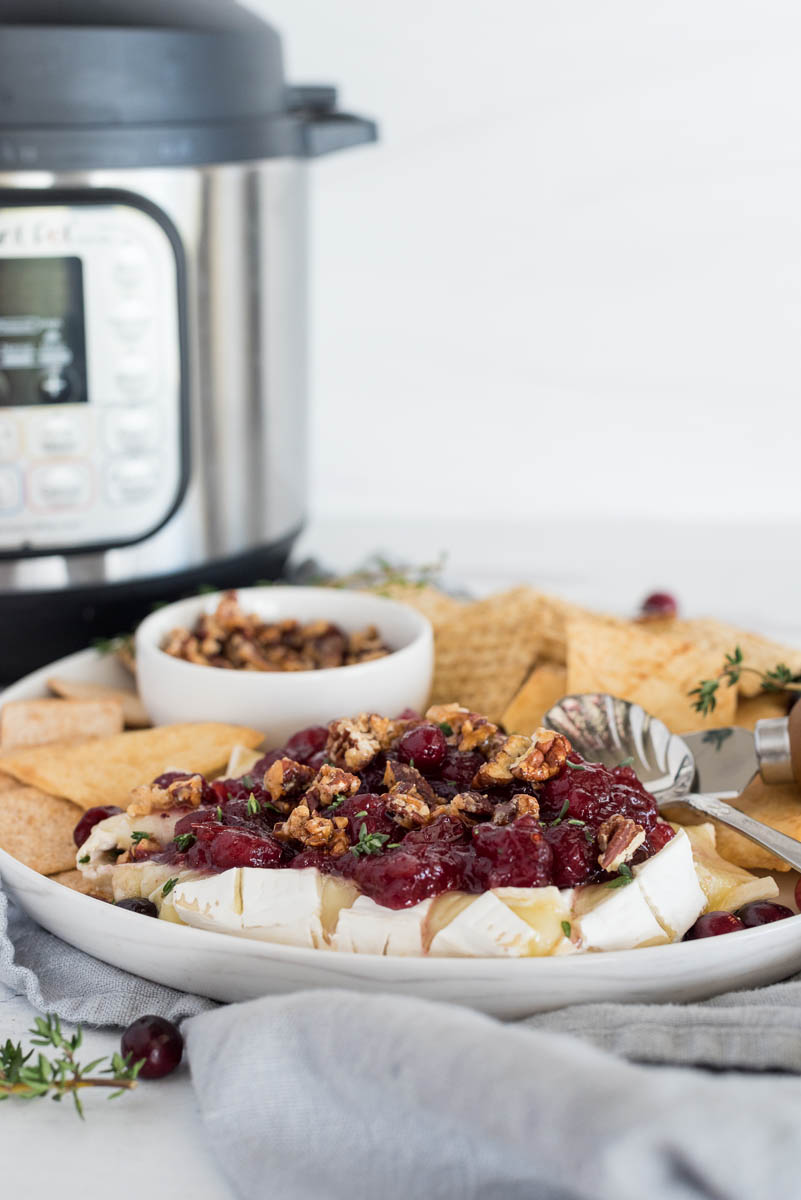 plate of baked brie in front of an instant pot