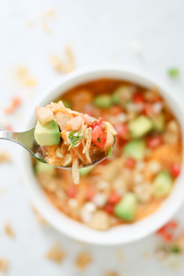 close up photo of a spoon full of Instant Pot Creamy Enchilada Soup