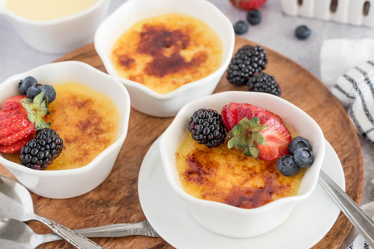 three ramekins of creme brulee with sugar crust