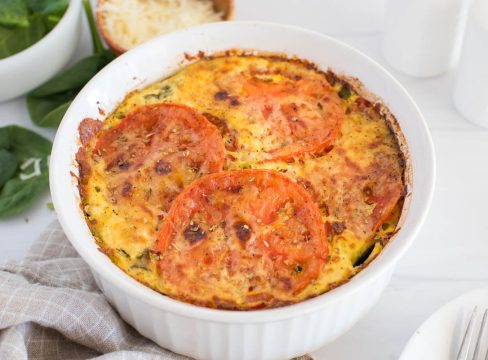 Close up of Instant Pot crustless spinach quiche topped with sliced tomatoes