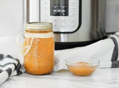 Dulce de leche in a bowl and in a mason jar and placed in front of an Instant Pot.