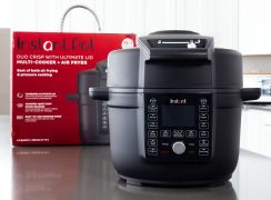 A picture from the front of the Instant Pot Duo Crisp with Ultimate Lid with the packaging box behind.