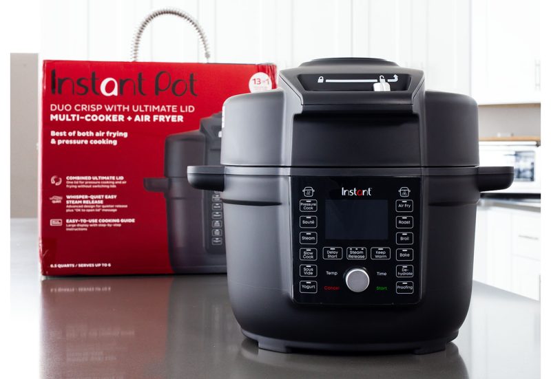 A picture from the front of the Instant Pot Duo Crisp with Ultimate Lid with the packaging box behind.