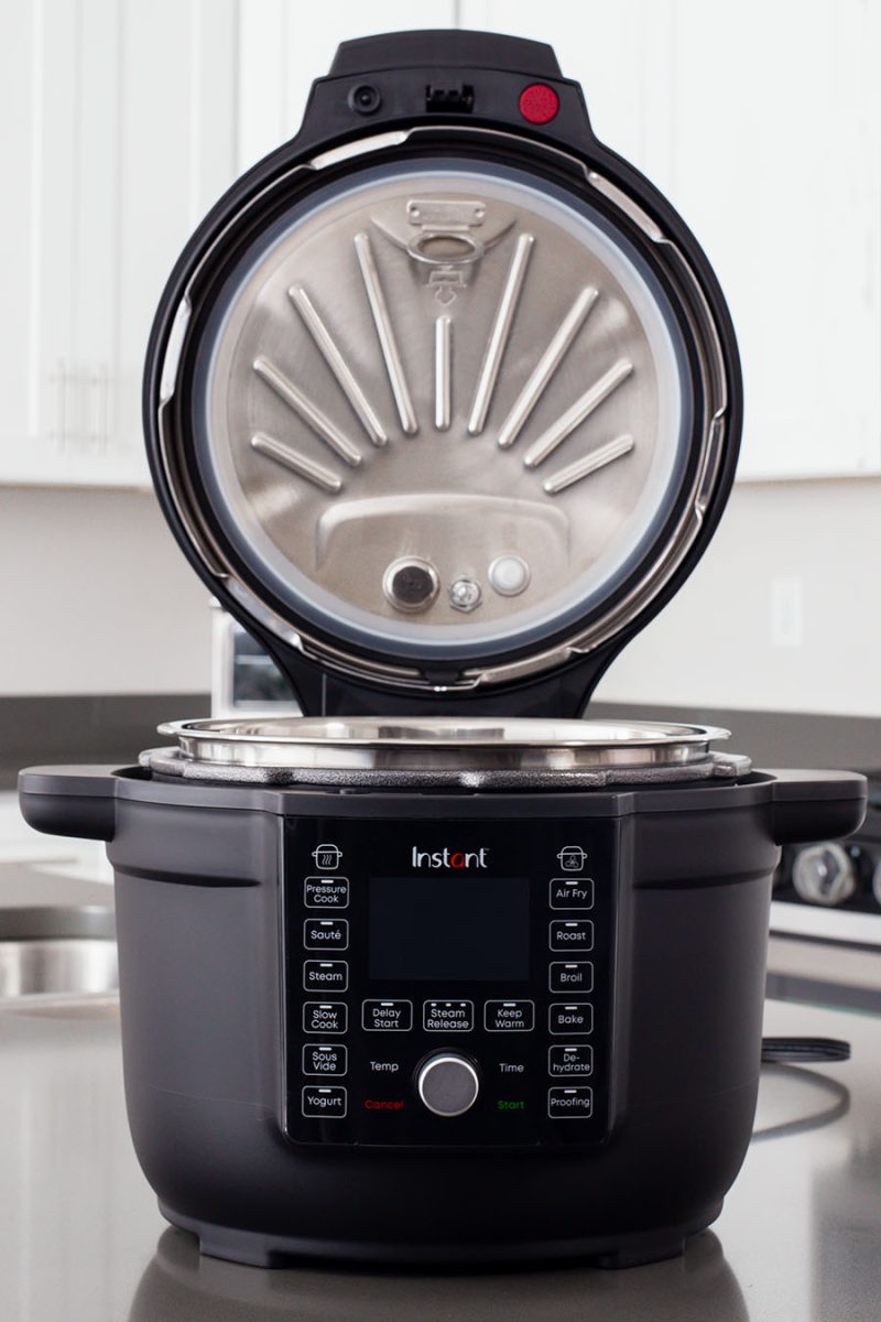 The Instant Pot Duo Crisp with Ultimate Lid from the front with the lid open featuring the pressure cooking lid insert.