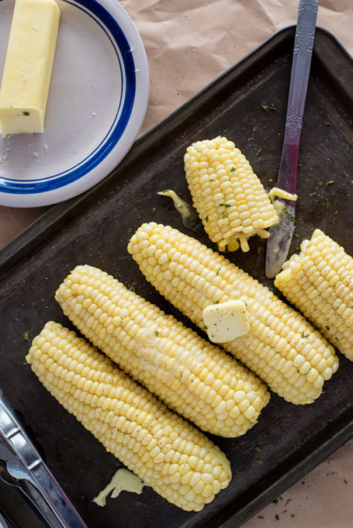 A pan full of corn on the cob, cooked and ready from the electric pressure cooker