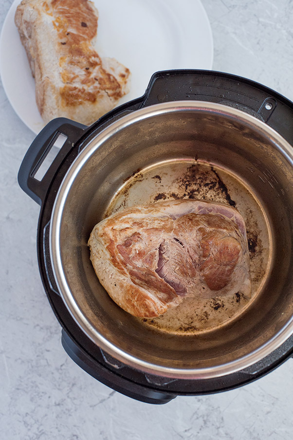 Pork shoulder browning inside an Instant Pot.