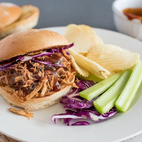 Instant Pot Pulled Pork sandwich, with cabbage, celery, and potato chips