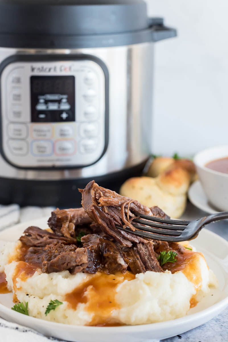 plate of instant pot beef with mashed potatoes
