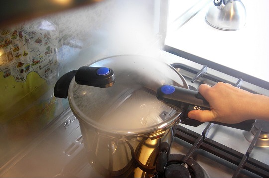 steam release from a standard pressure cooker on the stove