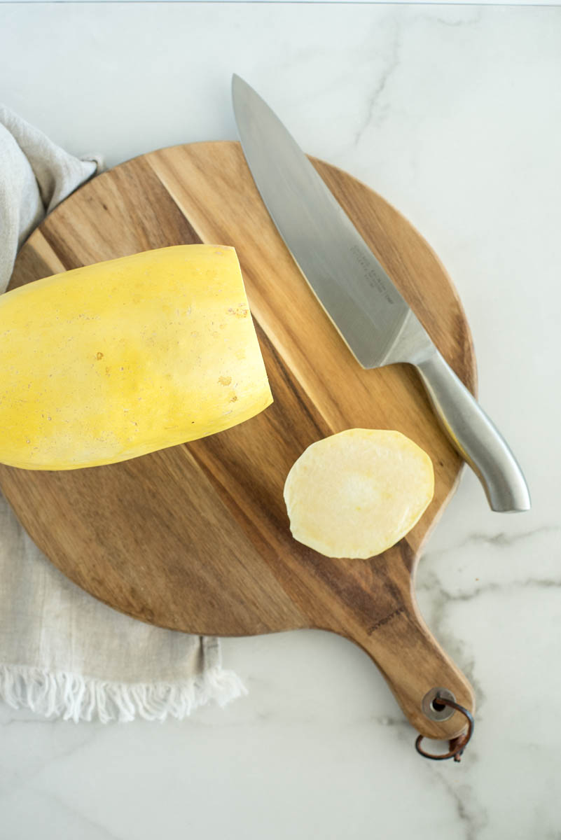 an overhead shot showing the top of the spaghetti squash sliced off to make a solid flat edge for cutting