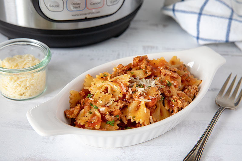 A plate of food on a table, with Cook and Pasta