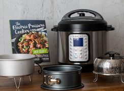 Electric Pressure Cooker Cookbook along with several of my favorite pressure cooking accessories (cake pan, trivet, springform, and steamer)