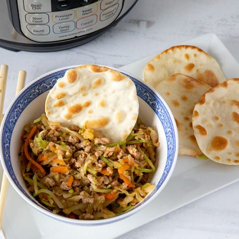 Instant Pot Egg Roll Bowls, dished up in a small bowl and ready to serve with wonton wrappers