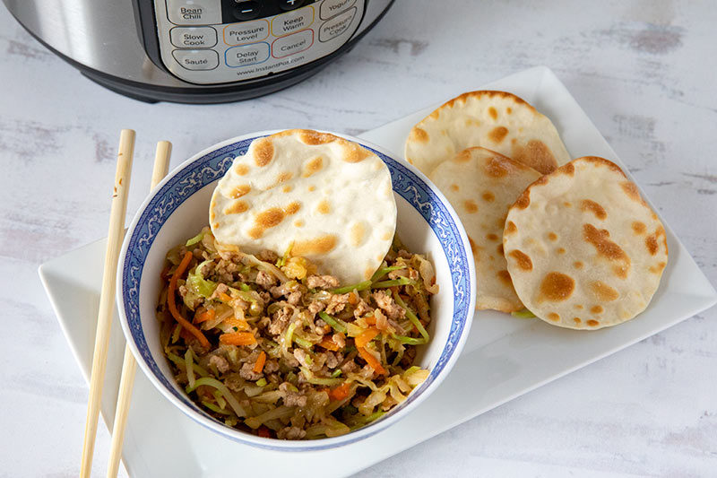 Instant Pot Egg Roll Bowls, dished up in a small bowl and ready to serve with wonton wrappers