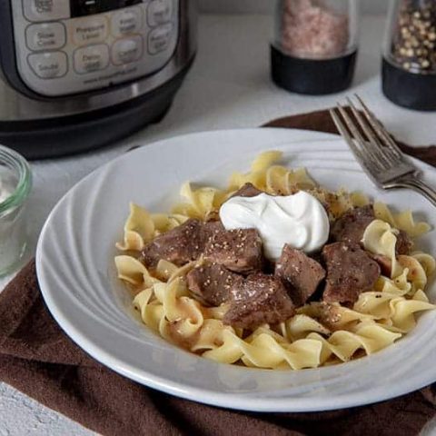 Sirloin-Tips-in-Gravy over noodles served on a white plate