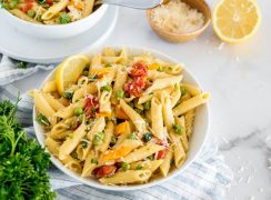 bowl of instant pot pasta primavera with fresh vegetables and parmesan cheese on top