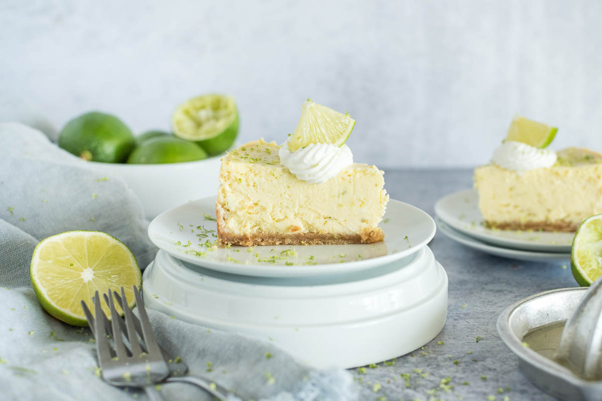 slice of instant pot key lime pie with cream and lime slices on top