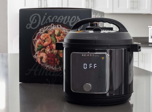 Instant Pot Pro Plus on a kitchen counter with the box in the background.