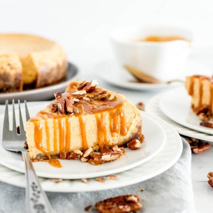 slice of pumpkin cheesecake drizzled with caramel sauce