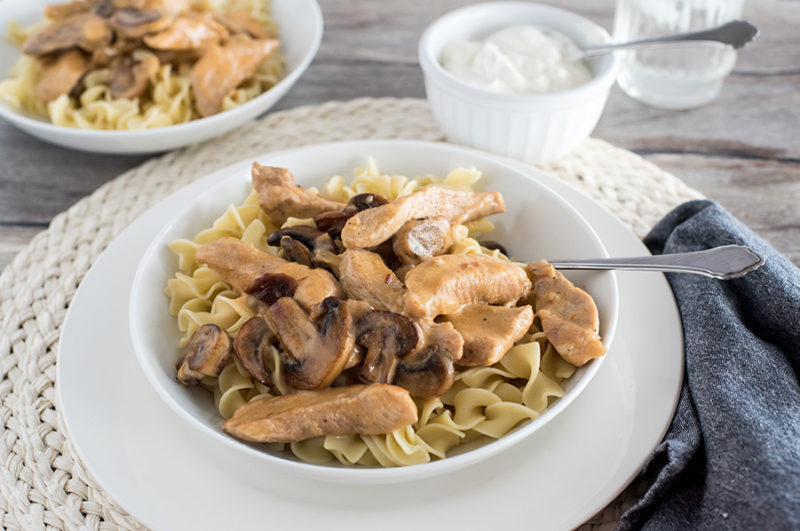 Instant Pot / Pressure Cooker Pork Stroganoff, dished up over egg noodles