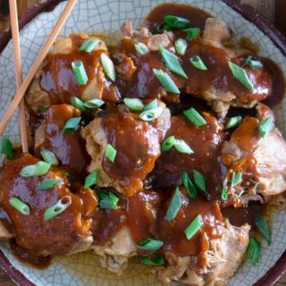 Pressure Cooker (Instant Pot) Korean Chicken Thighs on a serving platter, garnished with fresh scallions