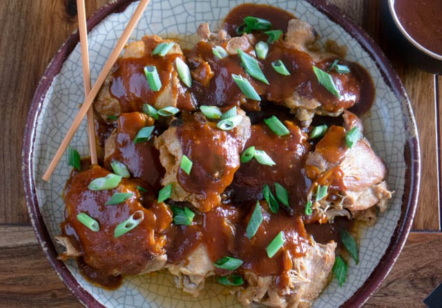 Pressure Cooker (Instant Pot) Korean Chicken Thighs on a serving platter, garnished with fresh scallions