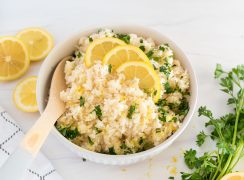 white bowl of instant pot lemon rice with a wooden spoon