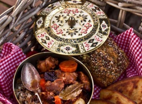 Pressure Cooker ((Instant Pot) Lamb Stew with Dried Plums in a decorative pot with a spoon