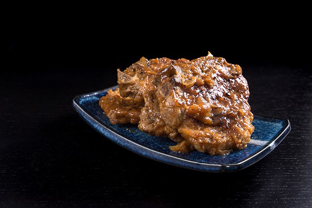 blue platter holding Maple Dijon Mustard Pork Chops made in a pressure cooker