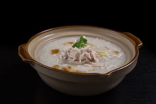 Pressure Cooker Chicken Porridge in a terra cotta soup bowl