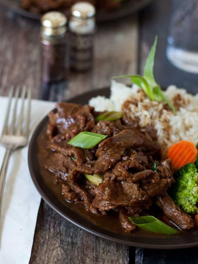 a close-up photo fo mongolian beef served with white rice and broccoli