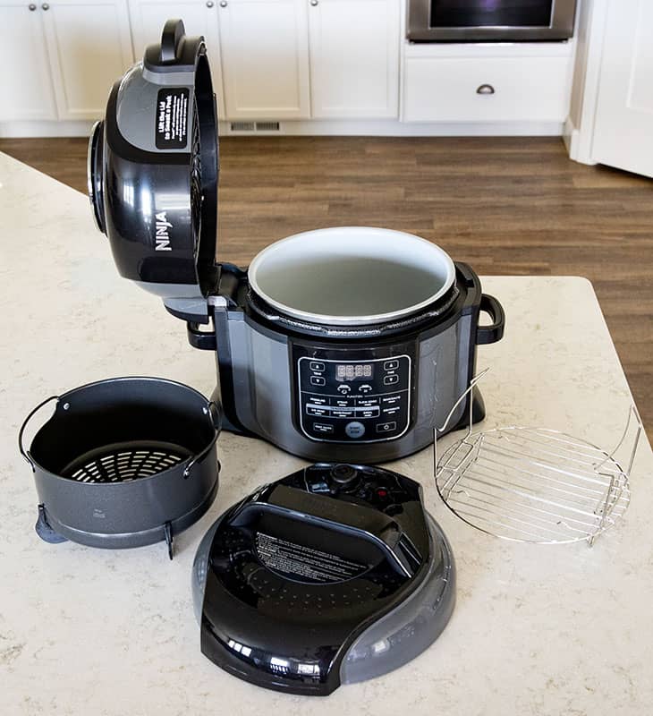 Ninja Foodi with the pressure cooking lid, trivet and basket accessories