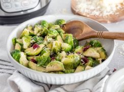 a close-up 45 degree shot of brussels sprouts being dished up by a wooden spoon